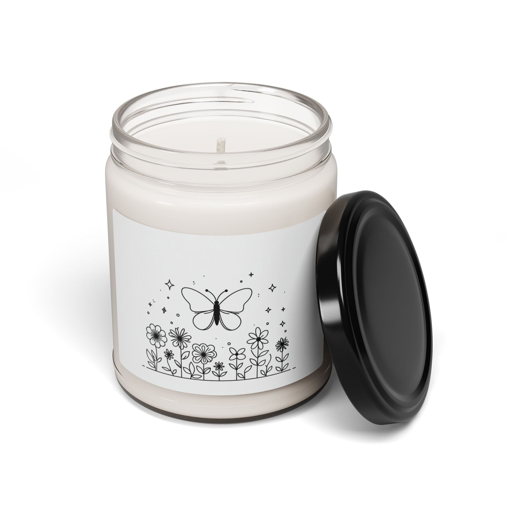 This scented candle is a black-and-white illustration features a whimsical butterfly hovering above a garden of blooming flowers.